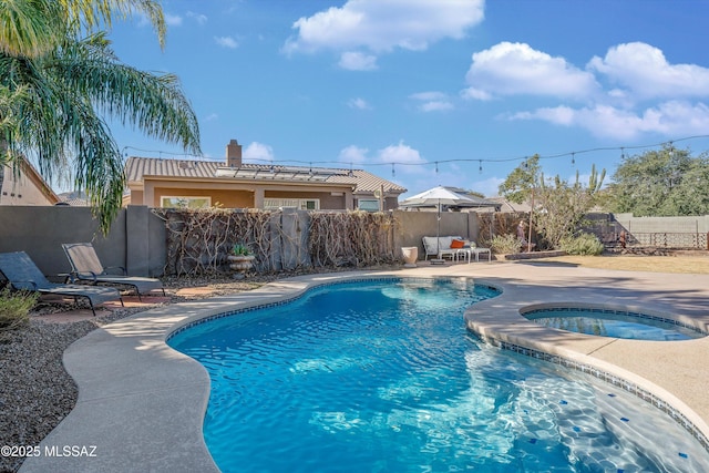 view of swimming pool featuring an in ground hot tub and a patio