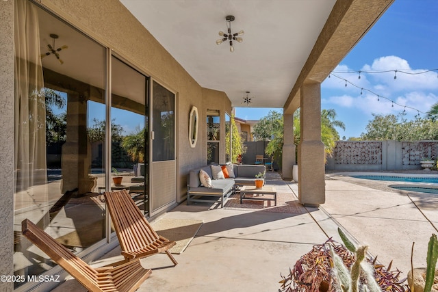 view of patio featuring a swimming pool with hot tub and an outdoor hangout area