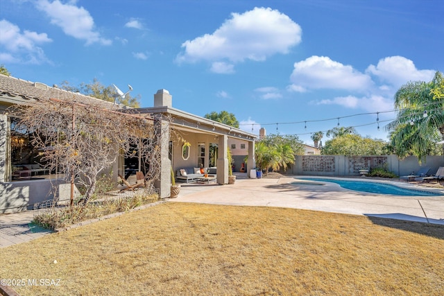 view of swimming pool featuring a patio area, a jacuzzi, and a yard