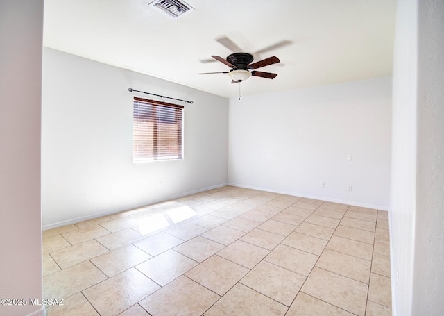 spare room with ceiling fan and light tile patterned floors