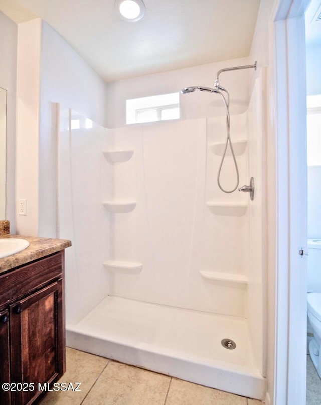 bathroom featuring a shower, tile patterned floors, toilet, and vanity