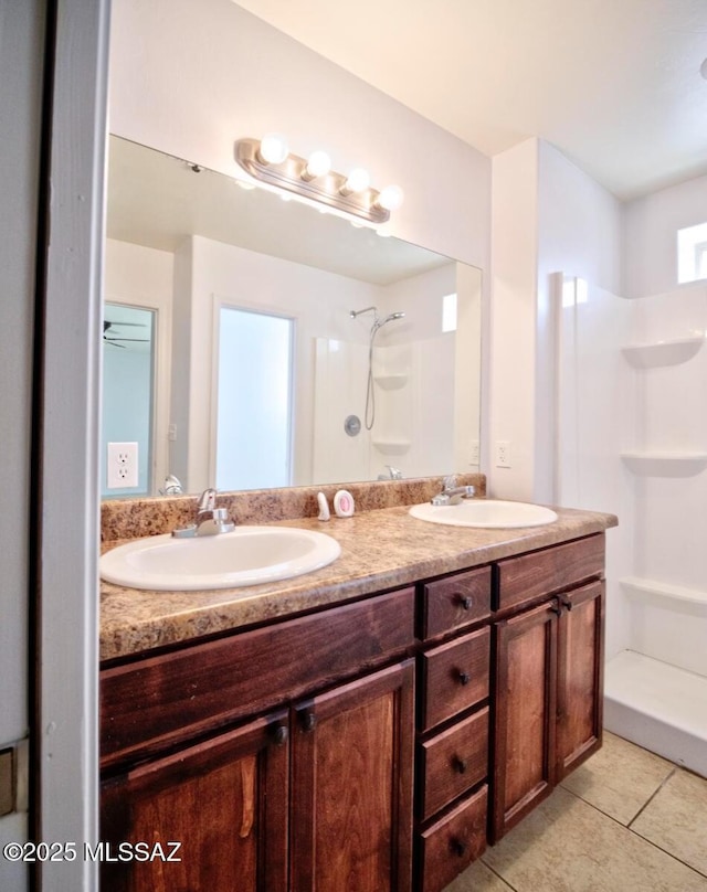 bathroom with vanity, a shower, and tile patterned floors