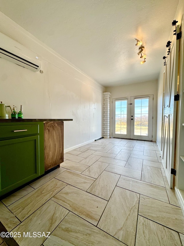 living room featuring french doors and a wall mounted AC