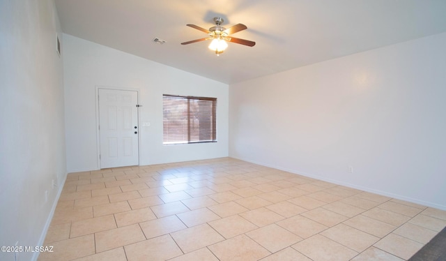 tiled empty room with ceiling fan and lofted ceiling