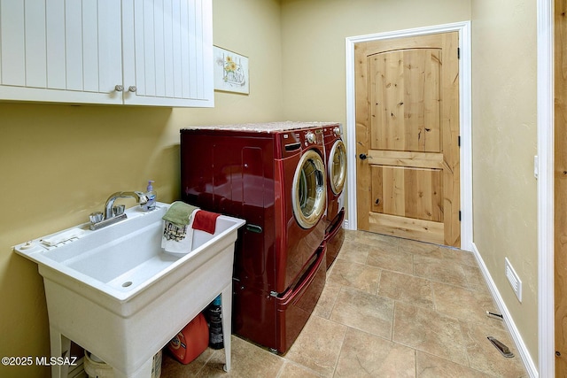 laundry room with cabinets, sink, and washer and dryer