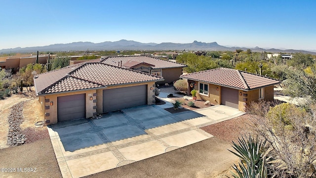 mediterranean / spanish-style home featuring a garage and a mountain view