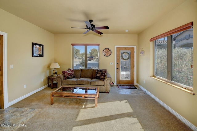 carpeted living room with ceiling fan