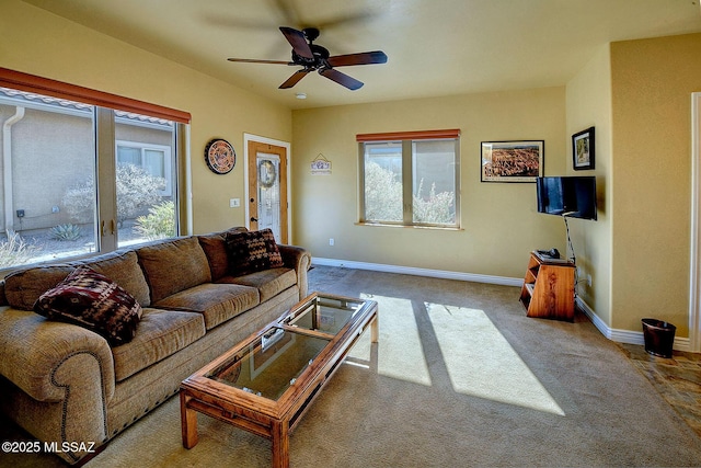 carpeted living room with ceiling fan