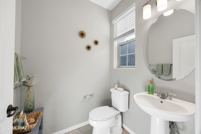 bathroom featuring tile patterned floors, toilet, and sink