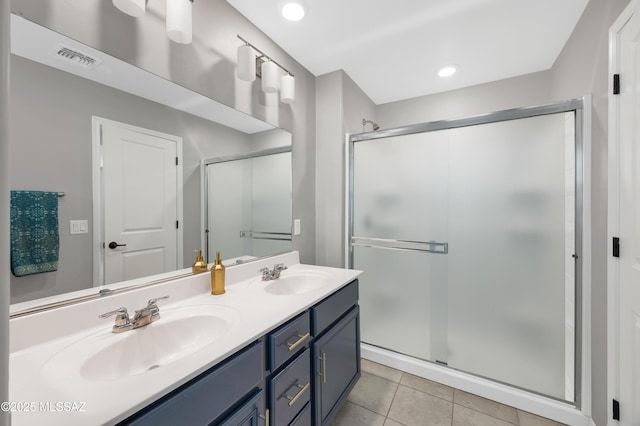 bathroom with vanity, a shower with shower door, and tile patterned flooring