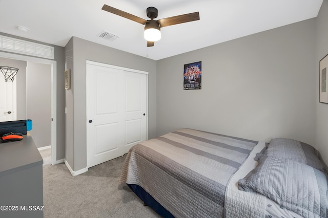 carpeted bedroom featuring a closet and ceiling fan