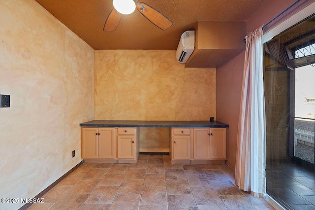 interior space with a wall mounted air conditioner and ceiling fan