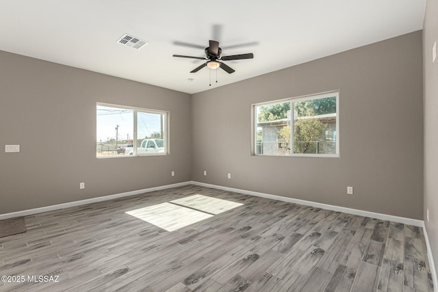 unfurnished room with ceiling fan, plenty of natural light, and light hardwood / wood-style flooring