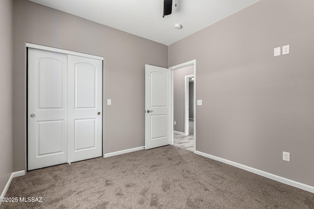 unfurnished bedroom featuring ceiling fan, light colored carpet, and a closet