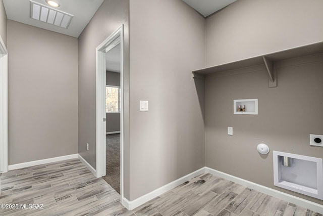 laundry area featuring hookup for a gas dryer, washer hookup, hookup for an electric dryer, and light hardwood / wood-style floors