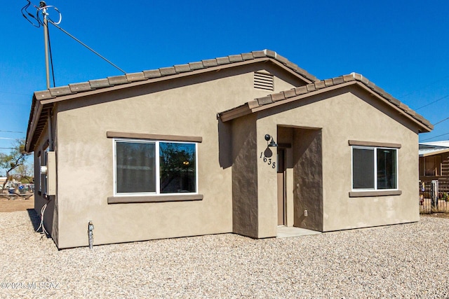 rear view of property featuring a patio