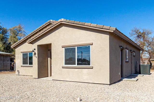 rear view of property featuring cooling unit