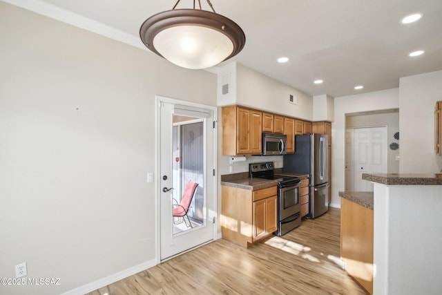 kitchen with stainless steel appliances, hanging light fixtures, and light wood-type flooring