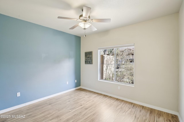 spare room with ceiling fan and light hardwood / wood-style floors