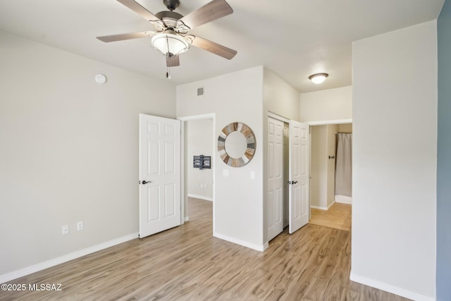 unfurnished room featuring ceiling fan and light wood-type flooring