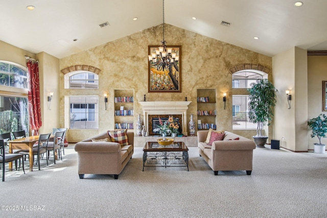 carpeted living room with a fireplace, high vaulted ceiling, and a notable chandelier