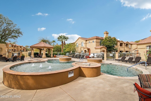 view of pool with a gazebo, pool water feature, and a patio