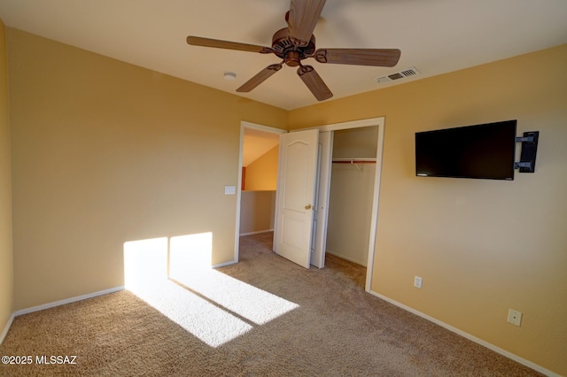 unfurnished bedroom with a closet, ceiling fan, and light colored carpet