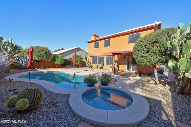 view of swimming pool with an in ground hot tub and a patio area