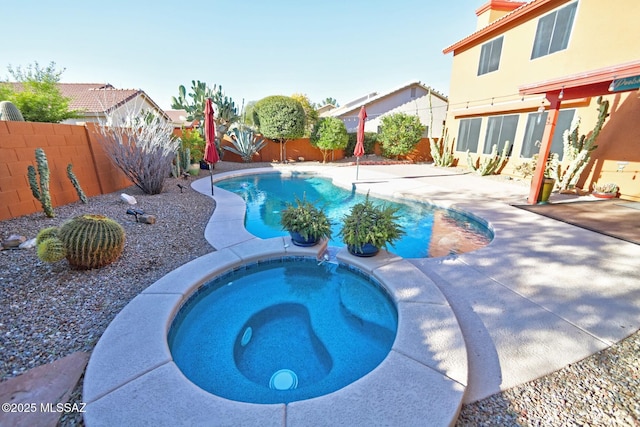 view of swimming pool with an in ground hot tub and a patio area