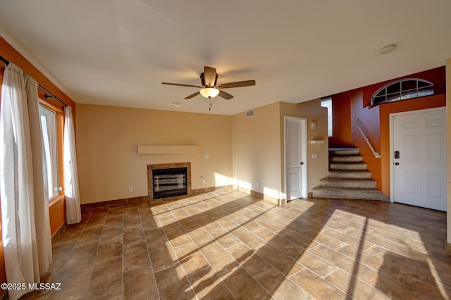 unfurnished living room with ceiling fan