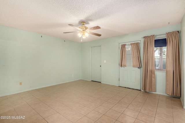 spare room featuring a textured ceiling and ceiling fan