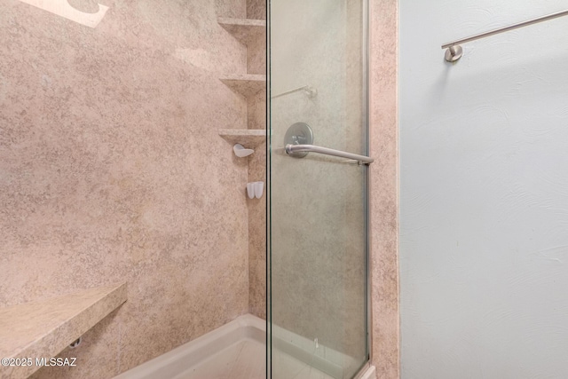 bathroom with tiled shower