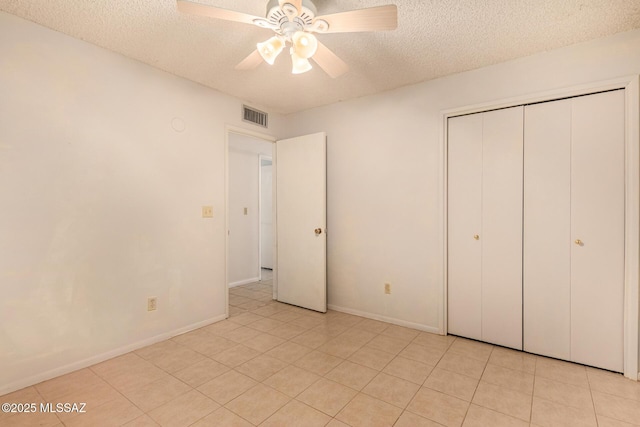 unfurnished bedroom featuring ceiling fan, a closet, and a textured ceiling