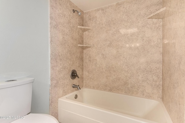 bathroom featuring tiled shower / bath and toilet