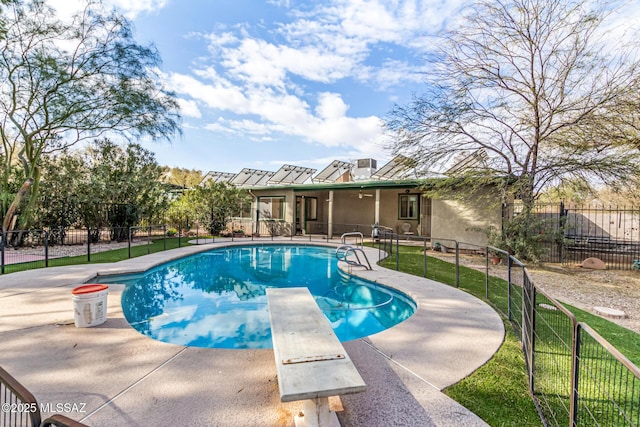 view of pool with a diving board