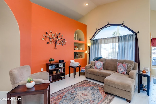 tiled living room with lofted ceiling and built in shelves