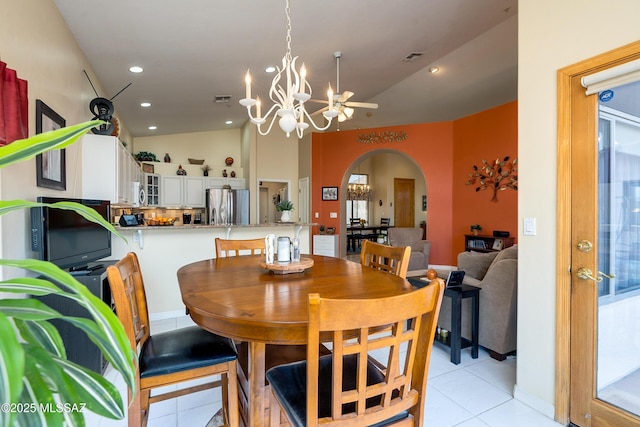 dining area featuring light tile patterned floors, vaulted ceiling, and a chandelier