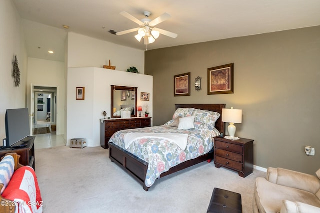 bedroom with lofted ceiling, light carpet, and ceiling fan