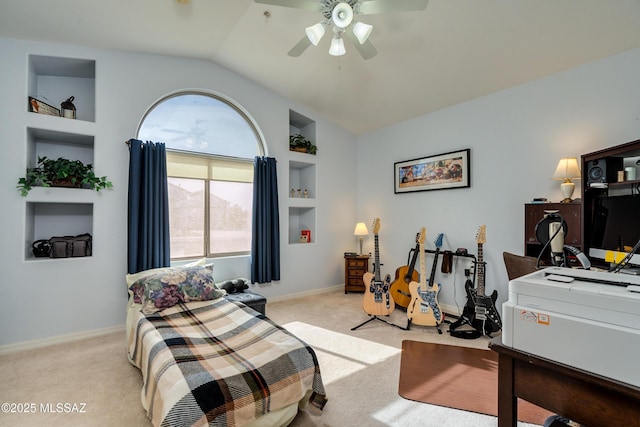 office space featuring ceiling fan, lofted ceiling, light carpet, and built in features