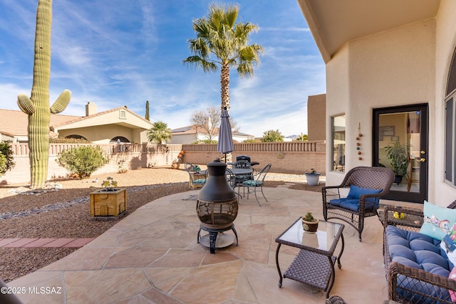 view of patio featuring an outdoor living space with a fire pit