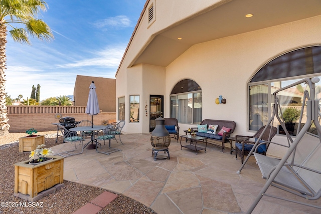 view of patio / terrace with an outdoor living space with a fire pit