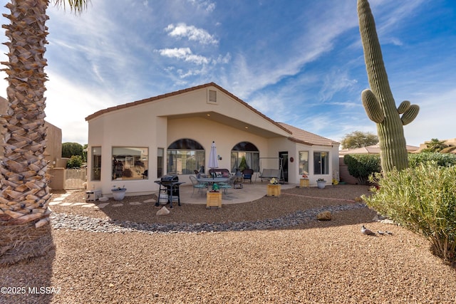 rear view of house with a patio