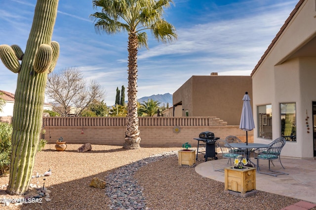 view of yard with a mountain view and a patio area