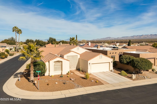 view of front of house with a garage and a mountain view