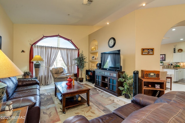 living room with sink, built in features, and light tile patterned floors