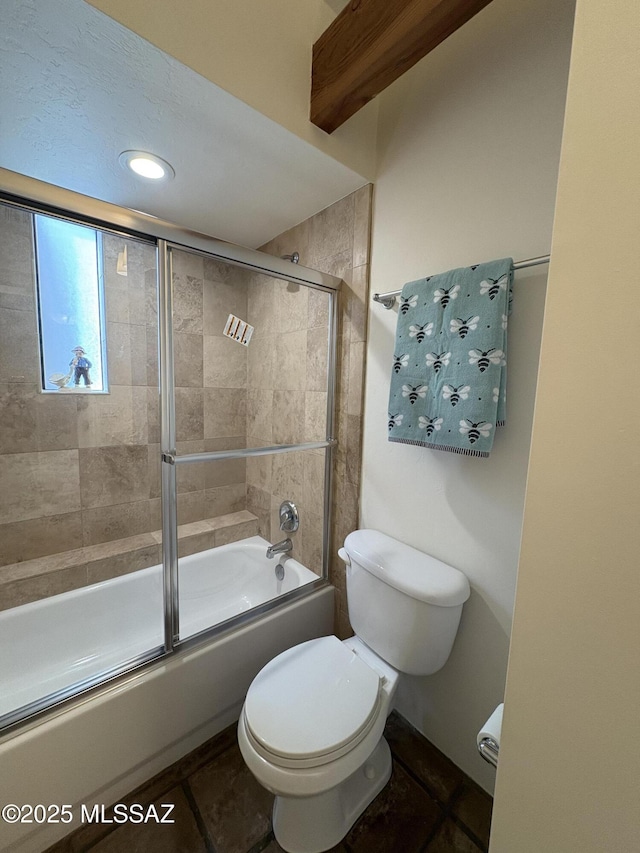 bathroom with toilet, tile patterned floors, and shower / bath combination with glass door