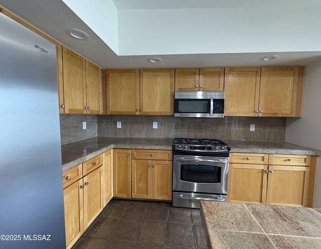 kitchen featuring appliances with stainless steel finishes and backsplash