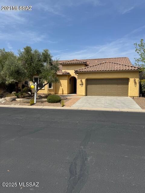 60782 E Arroyo Vista Dr, Oracle, AZ 85623 - view of front of property with concrete driveway, stucco siding, a tiled roof, and a garage