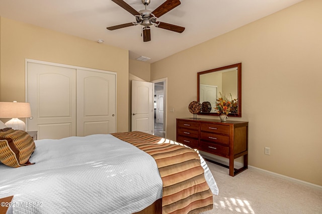 carpeted bedroom with ceiling fan and a closet