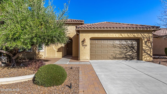 60782 E Arroyo Vista Dr, Oracle, AZ 85623 - mediterranean / spanish home featuring concrete driveway, stucco siding, an attached garage, and a tile roof